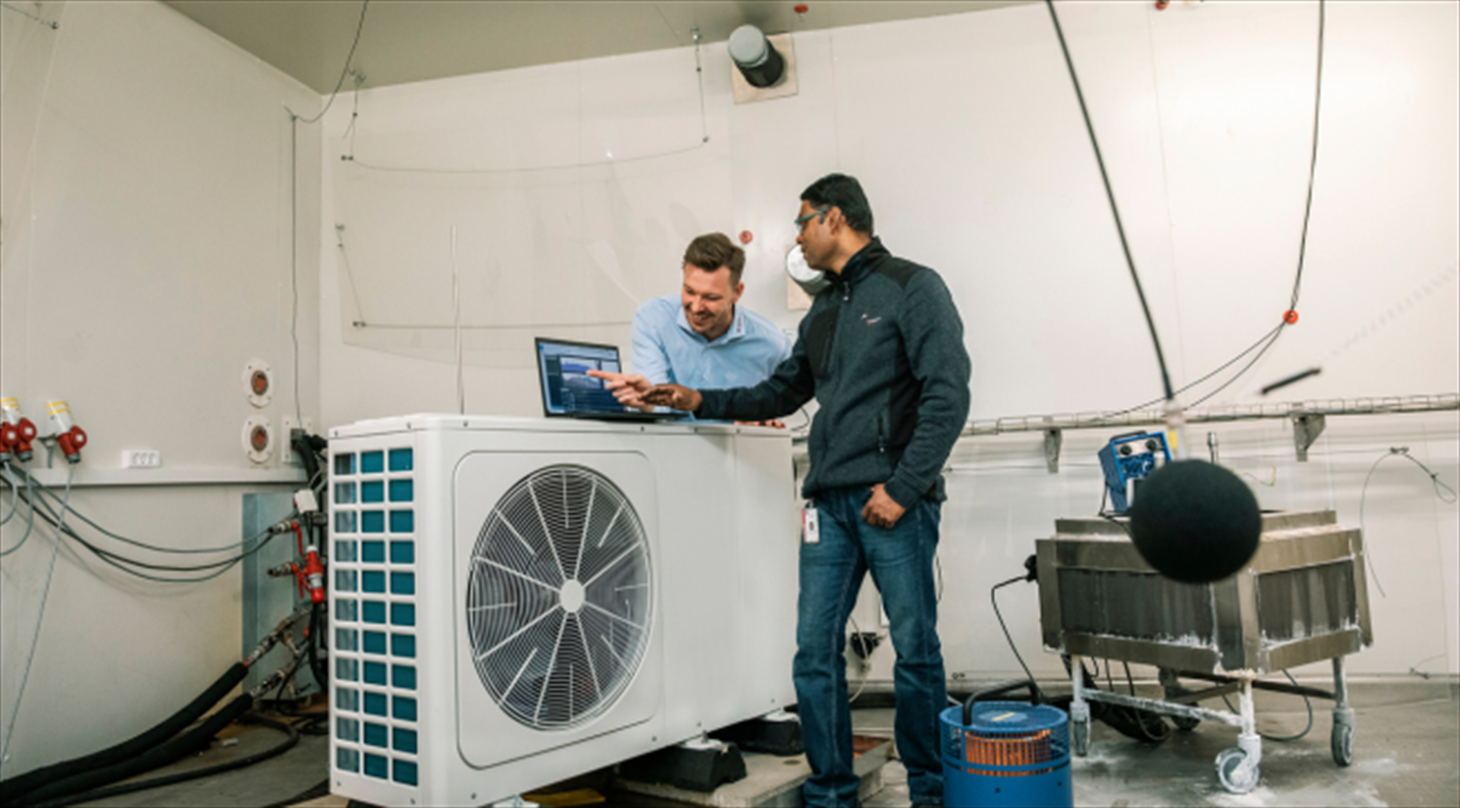 Two test engineers working inside a climate chamber in the Heat Pump Test Laboratory at Danish Technological Institute